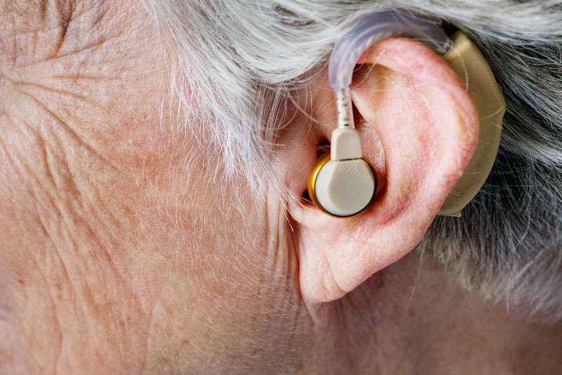 Close up image of a hearing aid inserted in an ear
