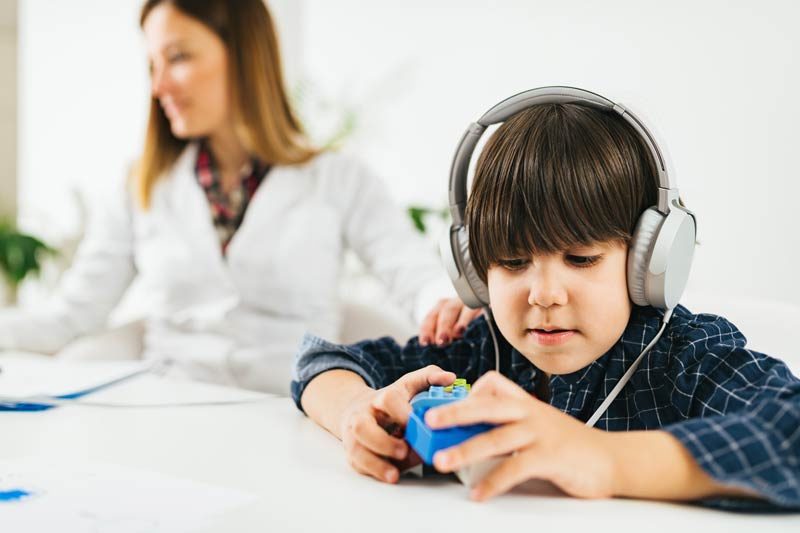 Little boy with headphones on getting a hearing test